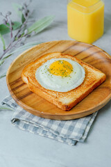 Fried egg crispy toast food on wood plate