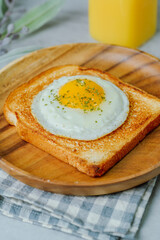 Fried egg crispy toast food on wood plate
