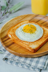 Fried egg crispy toast food on wood plate