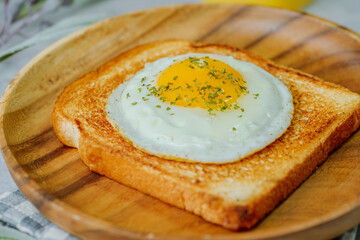Fried egg crispy toast food on wood plate