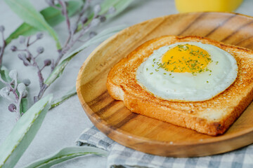 Fried egg crispy toast food on wood plate