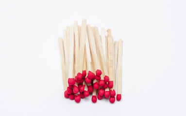 Pile of new unlit wooden matchsticks on white background
