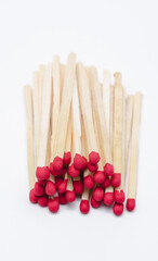 Pile of new unlit wooden matchsticks on white background