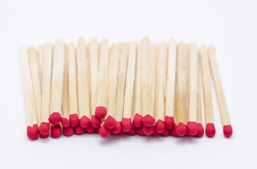Pile of new unlit wooden matchsticks on white background
