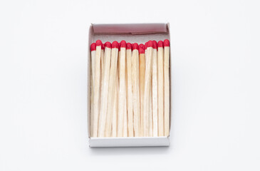 Set of new unlit matchsticks in a cardboard box on white background