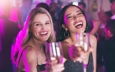 Portrait, party and toast with woman friends in a nightclub for a new year celebration together....