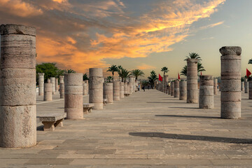 People walking around the medieval columns next to the Hassan tower in Rabat, Morocco - obrazy, fototapety, plakaty