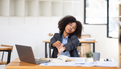 Feeling tired and stressed, workload, burnout and fatigue. Frustrated young african american woman keeping eyes closed and massaging nose after work at laptop for long time in office