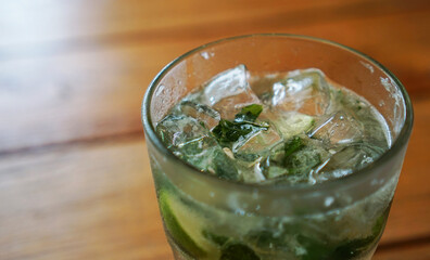A glass of iced lemonade with mint leaves