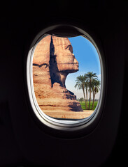 Landscape with Egyptian sphinx and palm trees in a frame of aircraft porthole window. Travel...