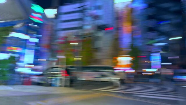 Hyperlapse of Tokyo Akihabara district, fast moving pedestrians in busy night street, asian nightlife and entertainment in Tokyo