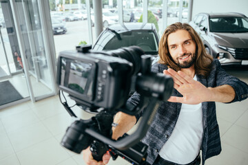 Social media influencer creating content. man shooting video of himself using camera on tripod....