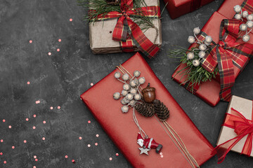 Beautiful gifts and sweet under the Christmas tree. New Year's decor. Preparation for the holiday. Many gifts on a dark background.