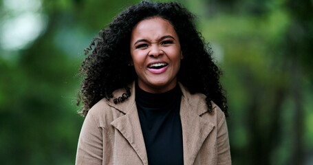 Positive happy black girl smiling and laughing outside