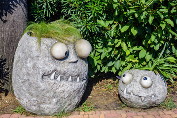 Sochi, Russia, August 13 -2022 Sochi-Park. Stone flowerbeds with funny expression stands in resort park. Sculptures illuminated by bright sun attracts tourists to explore