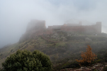 Obraz premium View of the Peracense Castle during an Autumn day with mist. Teruel, Aragon, Spain.