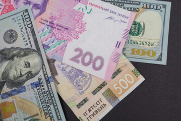 Fototapeta na wymiar dollars and hryvnia on a black