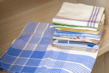 A stack of ironed handkerchiefs on a shelf