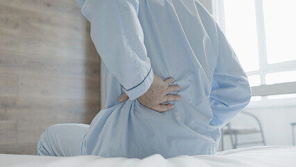 Male pensioner feeling back pain, symptom of osteoarthritis, joints degeneration
