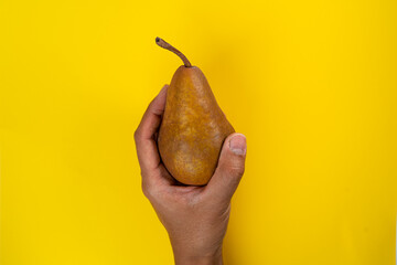 holding pear in the hand