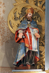 Obraz premium Saint Ambrose, statue on the main altar in the parish church of Saint John the Baptist in Gornji Desinec, Croatia