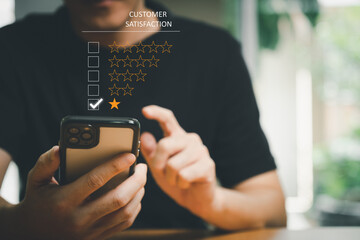 Selective focus at men hand while type on smartphone to give customer satisfaction feedback for...