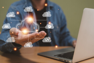 Selective focus at the icon with hand of human that holding cloud icon while who using internet and personal cloud storage to keep information and payment data, upload over the internet.
