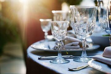 empty wine glasses on the table.table setting for a festive dinner. solar glare.