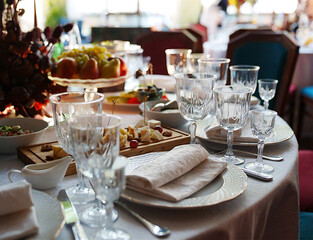 table setting for a festive dinner. empty wine glasses, tableware and snacks.