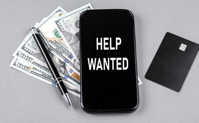 Credit card and text HELP WANTED on smartphone with dollars and pen. Business concept