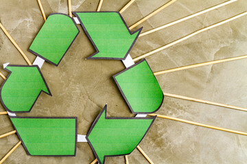 Close up green recycle sign and many wooden sticks. Green world concept.
