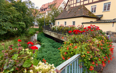 Fototapeta na wymiar Beautiful flower decoration on bridge railing in the old town of Schwabach, Germany