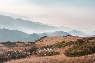 Mountains landscape with some people hiking. Sunset or sunrise in mountains. 