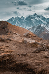 Mountains landscape with some people hiking. Sunset or sunrise in mountains. 