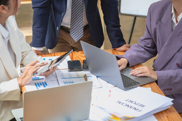 Team of Asian businessmen helping to brainstorm management ideas for the company are expressing joy and happiness that the company has achieved commercial success.