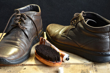 Leather shoes and a brush to clean them.