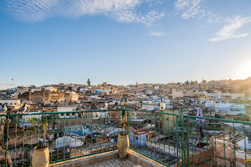 Medina of Fez skyline with pigeons resting on rooftop terrace at sunset, Fez, Morocco