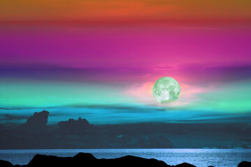 green moon and tree on the silhouette mountain on sunset sky
