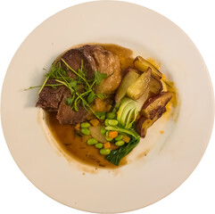 Prepared white dinner plate on table top with wood motif with beef stew with large edge of fat, green beans, sliced bok choy and roasted Roseval potatoes  topped with gravy