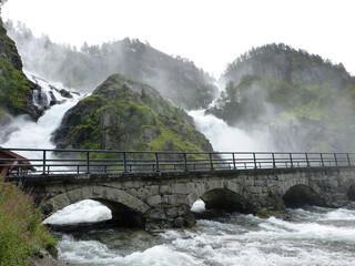 Latefos waterfall in Odda Norway with raging mountain stream and water mist