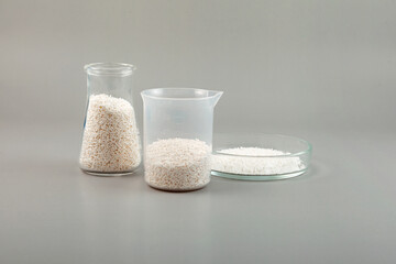 Potassium sorbate, granular potassium salt of sorbic acid in laboratory flasks and Petri dish. Food...