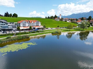 Obraz premium Hopfensee lake and town Hopenfen Swabia Bavaria Germany drone aerial view