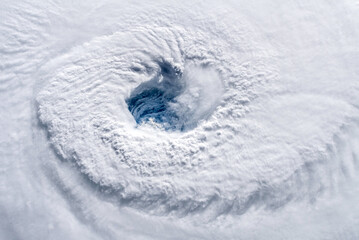Aerial view of a category 4 hurricane seen from space. The center, known as the eye of the...