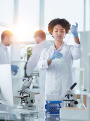 Smiling scientists looking at camera arms crossed in laboratory