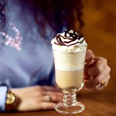 Girl holding milkshake close up