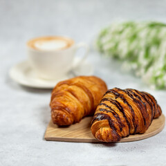 Croissant with coffee on white table. French breakfast.