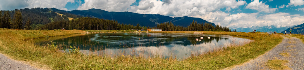Fototapeta premium High resolution stitched panorama with reflections at the famous Schmittenhoehe summit, Zell am See, Salzburg, Austria