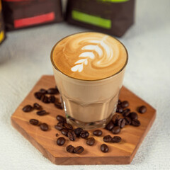 Coffee latte in tall glass with coffee beans