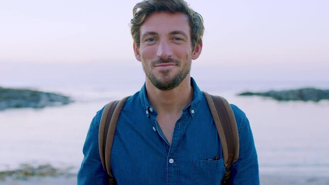 Man, face and happy smile on holiday, sunset and travel in Bali, beach and enjoy freedom, portrait and summer outdoor. Male tourist, happiness and traveling at the sea, ocean and calm happiness