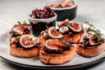 Bruschetta or ctostini with blue cheese and figs, tasty appetizer wine, banner, catering menu recipe place for text, top view